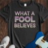 What A Fool Believes Unisex Cotton Tee